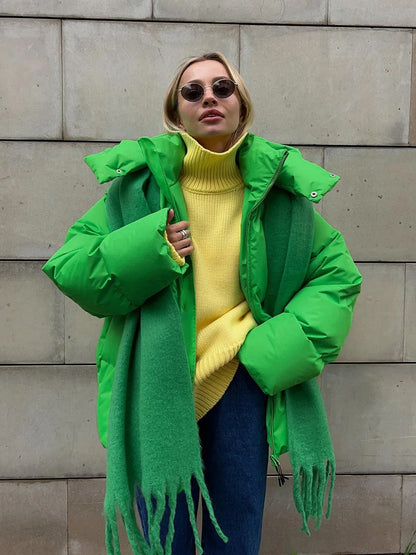 A women's oversized puffer jacket with a stylish design, featuring a cozy and relaxed fit, perfect for layering and providing warmth during the colder months.